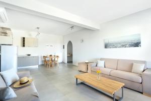 a living room with a couch and a table at Aithra -Agios Petros Andros in Gavrio