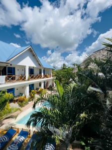 a view of a resort with a pool and palm trees at Hakuna Matata Boutique in Paje