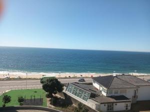 a view of a beach and a house and the ocean at Vila Mar Apartment in Vila do Conde