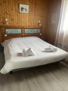 a bed with towels on it in a room at Le Domaine de la Caille - L'Hôtel in La Balme-de-Sillingy