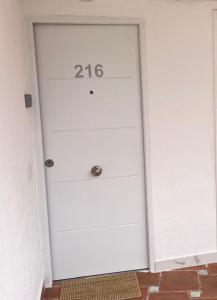 a white garage door with the number on it at Tenerife sea view 216 in Playa Fañabe