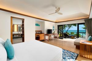a bedroom with a bed and a view of the ocean at SAii Phi Phi Island Village in Phi Phi Islands