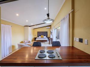 a living room with a table and a bedroom at Private Studio flatlet, Uncapped Wifi, Netflix,Full DSTV in Durban