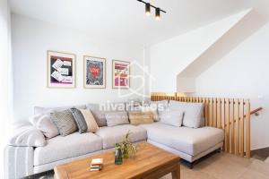 a living room with a couch and a coffee table at The Oasis El Medano, by Nivariahost in El Médano