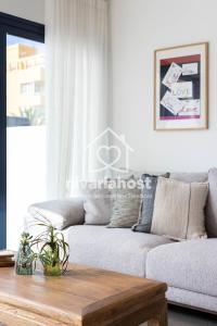a living room with a couch and a coffee table at The Oasis El Medano, by Nivariahost in El Médano