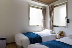 Postel nebo postele na pokoji v ubytování HOTEL WAN OSAKA EBISU