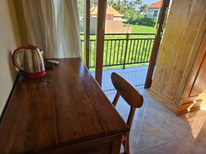 a wooden table with a blender on top of a balcony at KRISNA TAPAN GUEST HOUSE in Ubud