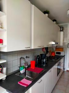 a kitchen with white cabinets and a sink at Appartamento Riviera Trilocale wifi e parcheggio privato in Ventimiglia