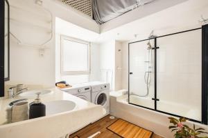 a bathroom with a sink and a washing machine at Luxury Apartment - Gordon Beach View 124 in Tel Aviv +53 photos