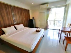 a bedroom with a large white bed and a desk at Grand Lopburi in Lop Buri +68 photos