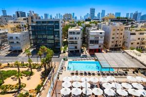 an aerial view of a city with a pool and buildings at Luxury Apartment - Gordon Beach View 124 in Tel Aviv
