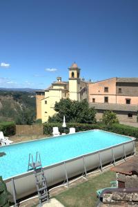 a large swimming pool in front of a building at Monolocale I Corbezzoli in San Michele in Teverina