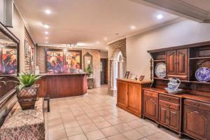 a large kitchen with wooden cabinets and a bar at Sunset Ridge Guest House in Rustenburg +35 photos
