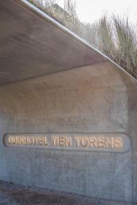 a sign on the side of a concrete road at Duinhotel Tien Torens in Zoutelande