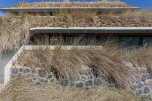 a pile of grass on the side of a building at Duinhotel Tien Torens in Zoutelande