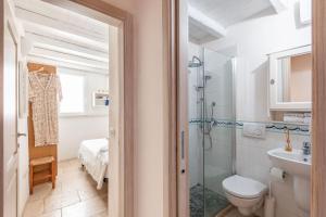 a bathroom with a shower and a toilet and a sink at Elena's house 28 in Polignano a Mare +34 photos