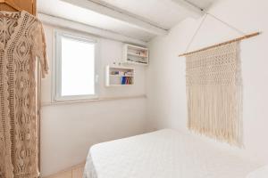 a small bedroom with a bed and a window at Elena's house 28 in Polignano a Mare
