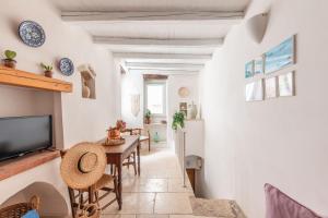 a living room with a table and a tv at Elena's house 28 in Polignano a Mare