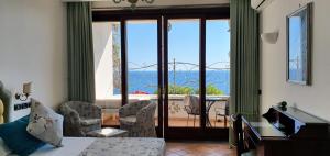a room with a room with a view of a balcony at Albergo La Conca Azzurra in Conca dei Marini