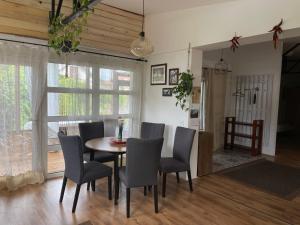 a dining room with a table and chairs at Bodrog-Parti Lodge in Sárospatak