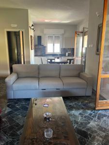 a living room with a couch and a coffee table at Casa Giovenza in Porto Azzurro