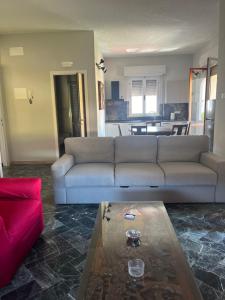 a living room with a couch and a table at Casa Giovenza in Porto Azzurro