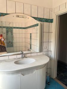 a bathroom with a sink and a mirror at Casa Giovenza in Porto Azzurro
