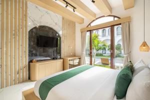 Ένα ή περισσότερα κρεβάτια σε δωμάτιο στο Cove Ume Nerus Residences & Villa