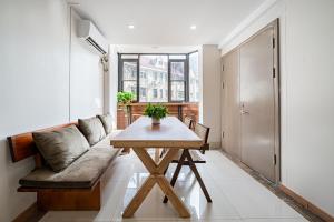 a living room with a wooden table and a couch at Denpa Inn - The Bund East Nanjing Road in Shanghai