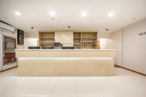 a bar in a restaurant with a counter at Denpa Inn - The Bund East Nanjing Road in Shanghai +28 photos