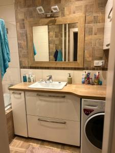 a bathroom with a sink and a washing machine at Your Home in Košice