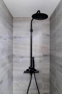 a black floor lamp in a shower in a room at Villa Brachychiton in Ostuni