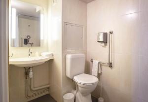 a bathroom with a toilet and a sink at B&B HOTEL Avignon 1 in Le Pontet