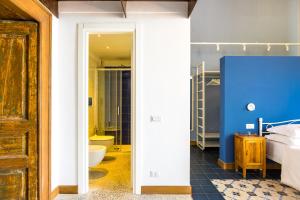 a bedroom with a bed and a bathroom at Starhost - ANGOLO FELICE, charming seaview terrace in Vietri sul Mare +83 photos