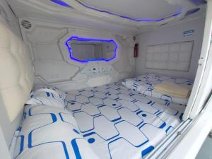 a room with two beds in a van at Happy Garden in Kampong Tenompok