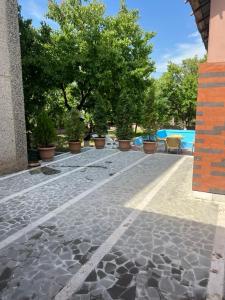 a patio with potted plants and a swimming pool at Jrvezh House in Yerevan +19 photos