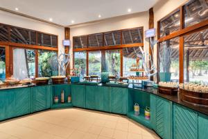 a restaurant with green counters and windows at SAii Phi Phi Island Village in Phi Phi Islands