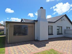 モッセル・ベイにあるCosy beach house in Diazの大きなガレージが目の前にある家