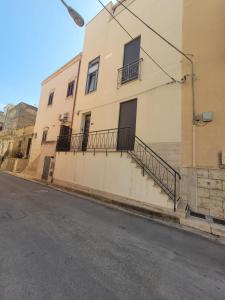 a building with stairs on the side of a street at Il Girasole in Paceco +8 photos