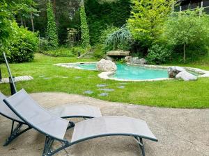 a chair sitting in front of a swimming pool at Cal Roig - Pedraforca in Saldés