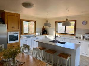 Nectar BrookSpear Creek Beach House的带水槽和带椅子的柜台的厨房 更多15张照片