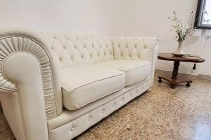 a white couch in a living room with a table at C'Era una Volta Velino Sirente National Park in Celano