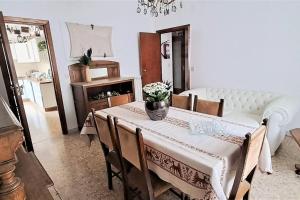 a dining room with a table with a vase of flowers on it at C'Era una Volta Velino Sirente National Park in Celano