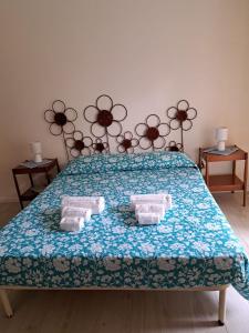 a bedroom with a bed with two towels on it at La Perla al mare 300mt from Perla Marina Beach in Santa Margherita di Pula
