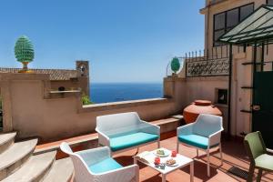 a patio with chairs and a table on a balcony at Casa Acropoli Sea View Taormina Center in Taormina +40 photos