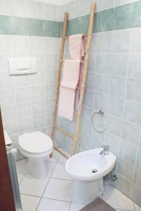 a bathroom with a toilet and a sink at La mansardina in Trieste