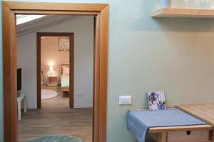 a hallway with a door leading to a bedroom at La mansardina in Trieste +7 photos
