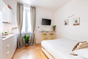 En eller flere senge i et værelse på Cantoni 4B - Studio at Colosseum + 10 billeder