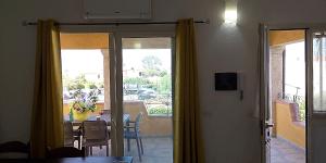 a dining room with a view of a table and chairs at Casa Marconi in San Teodoro