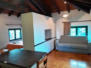 a kitchen and living room with a couch and a table at I Personaggi in Udine